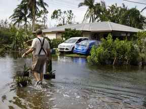 Un résident rentre chez lui dans une rue inondée après l'ouragan Ian à Fort Myers, en Floride, le jeudi 29 septembre 2022.