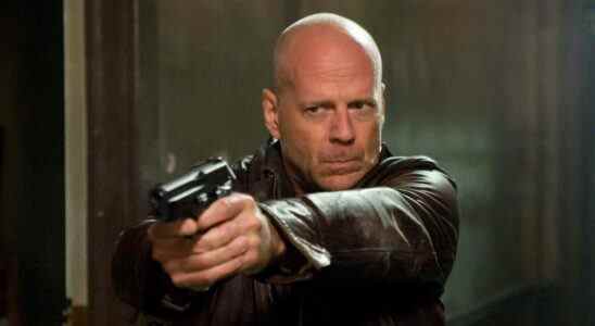 Bruce Willis as John McClane holding gun in A Good Day to Die Hard