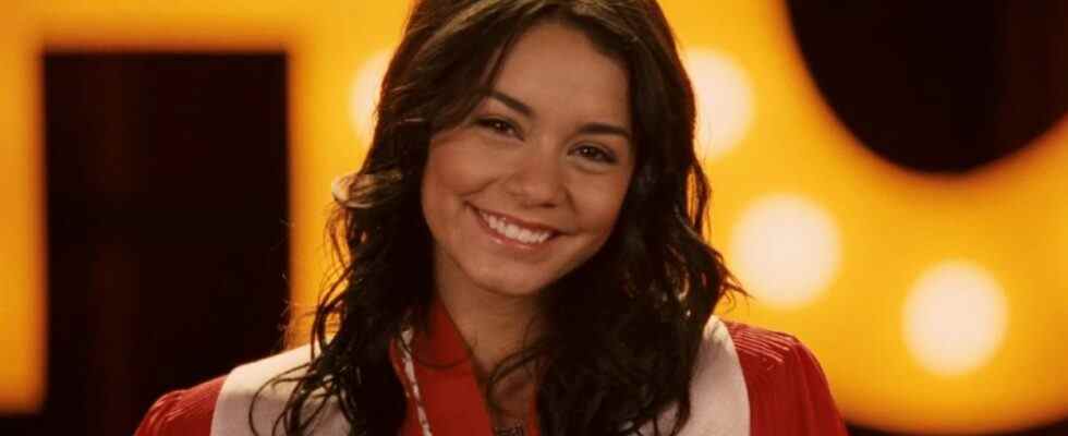 Vanessa Hudgens in High School Musical 3 smiling at the camera in a graduation robe.