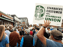 Les gens se rassemblent à l'extérieur d'un magasin Starbucks tandis que le chanteur Billy Bragg se produit pour les membres en grève du Starbucks Workers United Union à Buffalo, NY, en octobre.