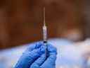 Une seringue est remplie d'une dose de vaccin COVID-19 de Pfizer dans un centre de vaccination communautaire éphémère au Gateway World Christian Center à Valley Stream, New York. 