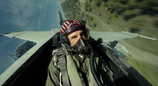 Helmeted Tom Cruise flying fighter plane in Top Gun: Maverick