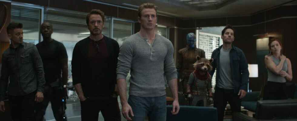 From left to right: Hawkeye, War Machine, Iron Man, Captain America, Nebula, Rocket, Ant-Man and Black Widow standing together out of uniform in Avengers: Endgame.