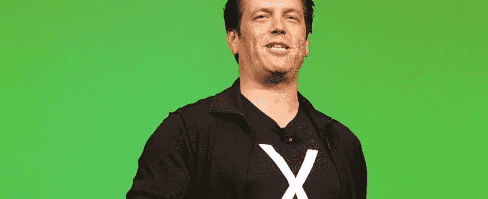 Phil Spencer giving a talk on stage, wearing a t-shirt with an