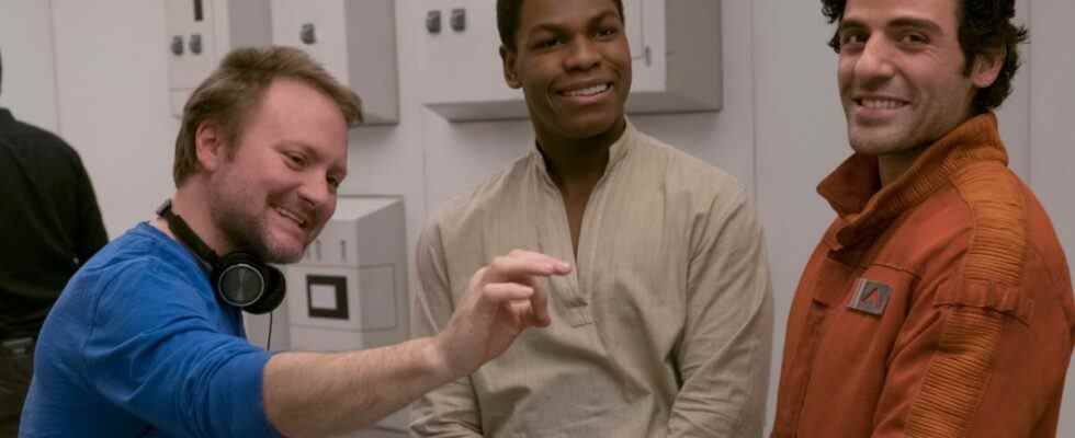 Rian Johnson directing John Boyega and Oscar Isaac on set with a laugh in Star Wars: The Last Jedi.