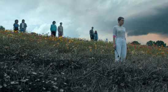 STRANGER THINGS. (L to R) Natalia Dyer as Nancy Wheeler, Charlie Heaton as Jonathan Byers, Finn Wolfhard as Mike Wheeler, Noah Schnapp as Will Byers, David Harbour as Jim Hopper, Winona Ryder as Joyce Byers, and Millie Bobby Brown as Eleven all stand in a field overlooking Hawkins in the season 4 part 2 finale