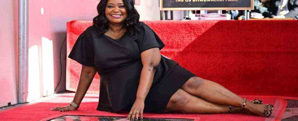 Octavia Spencer sitting with her star on the Hollywood Walk of Fame