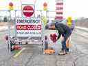 Tim Ferguson dépose des fleurs sur les lieux pendant que la police enquête sur le meurtre d'un agent de l'OPP sur Indian Line à Objiwa Road à l'ouest de Hagersville le mercredi 28 décembre 2022. Derek Ruttan/The London Free Press/Postmedia Network