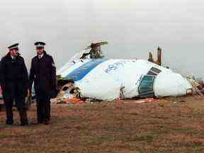 Dans cette photo d'archive prise le 22 décembre 1988, des policiers se tiennent près de l'épave de l'avion de ligne 747 Pan Am qui a explosé et s'est écrasé au-dessus de Lockerbie, en Écosse.
