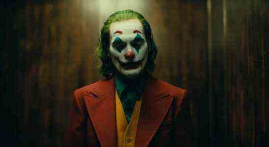 Joaquin Phoenix in full clown makeup standing in elevator during Joker