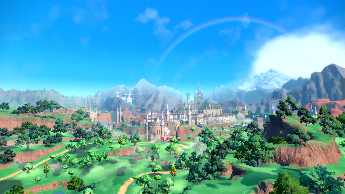 Une capture d'écran d'un paysage dans Pokémon Scarlet et Violet.  Il y a des collines escarpées, des arbres, une rivière et un chemin qui semble mener vers une ville fortifiée au loin.
