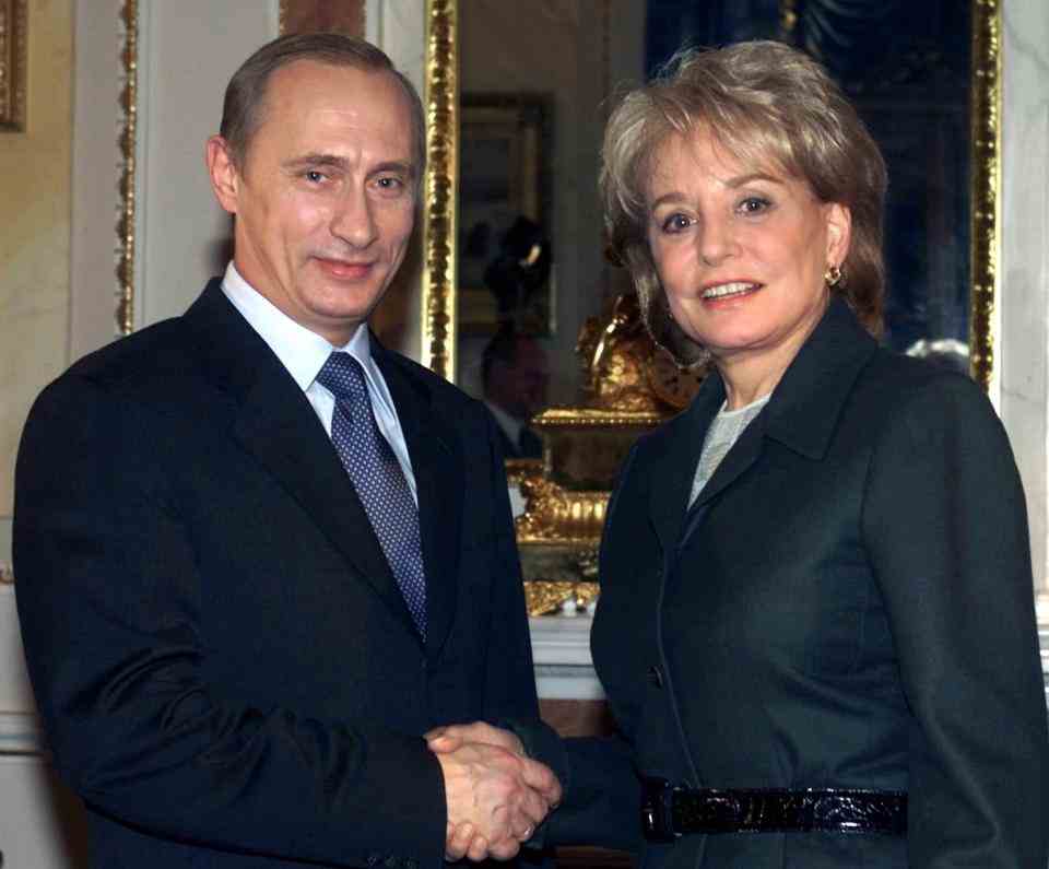 Avec Vladimir Poutine en 2001 - AP Photo/Mikhail Metzel