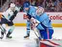 Sam Montembeault des Canadiens effectue un arrêt alors que Ryan Donata du Seattle Kraken et Joel Edmundson des Canadiens regardent la deuxième période d'un match de la Ligue nationale de hockey à Montréal le lundi 9 janvier 2023.
