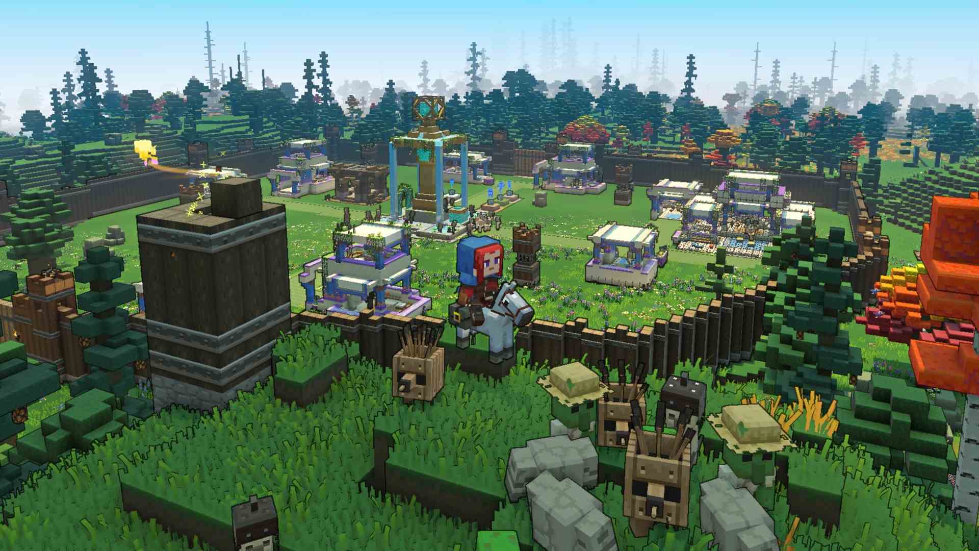 Le joueur de Minecraft Legends sur une monture se tient sur une colline herbeuse surplombant une base avec des murs en bois et plusieurs structures à l'intérieur.