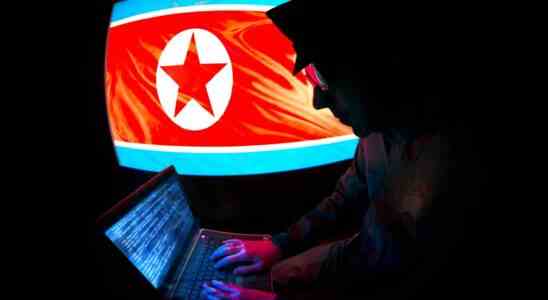 North Korean Officer is hacking on a laptop.