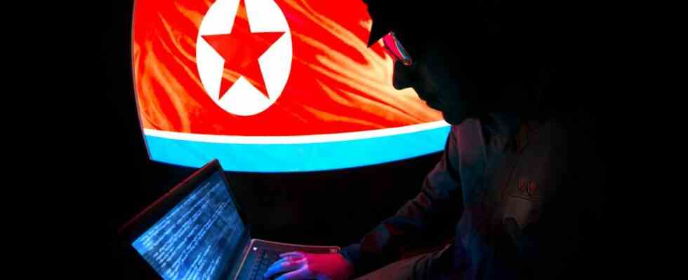 North Korean Officer is hacking on a laptop.