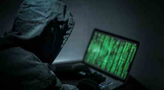 Hacker hacking on a laptop.