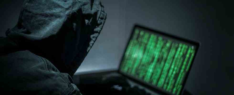 Hacker hacking on a laptop.