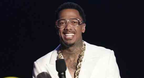 Nick Cannon wearing glasses and smiling on The Masked Singer