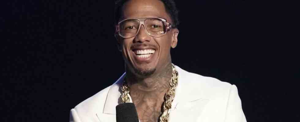 Nick Cannon wearing glasses and smiling on The Masked Singer