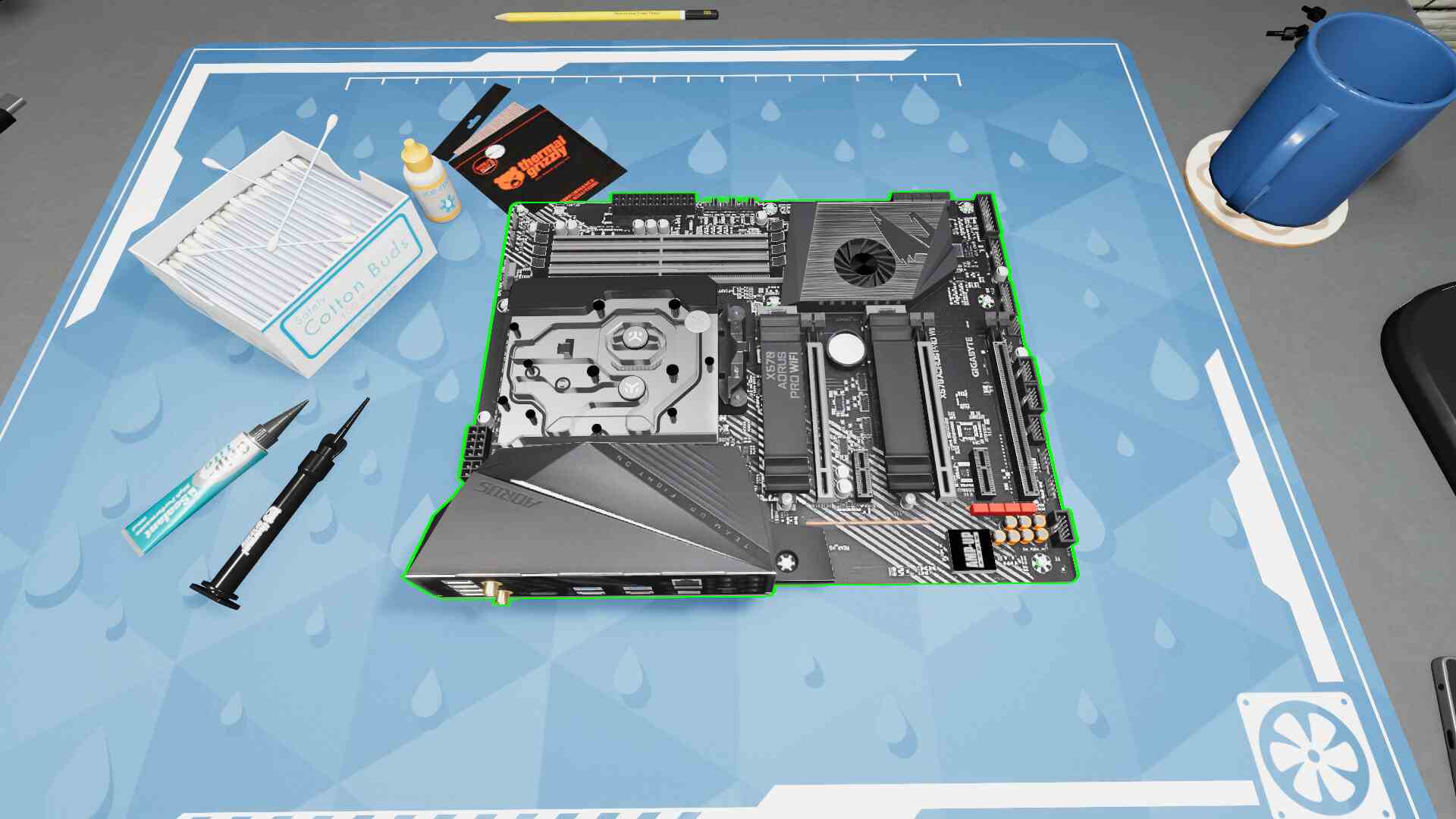 Une capture d'écran de PC Building Simulator 2, dans laquelle une carte mère vide repose sur un bureau, entourée d'accessoires tels que de la pâte thermique