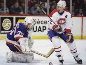Le gardien des Islanders de New York Tommy Soderstrom arrête l'ailier des Canadiens de Montréal Mike Keane à Montréal le 20 février 1995.