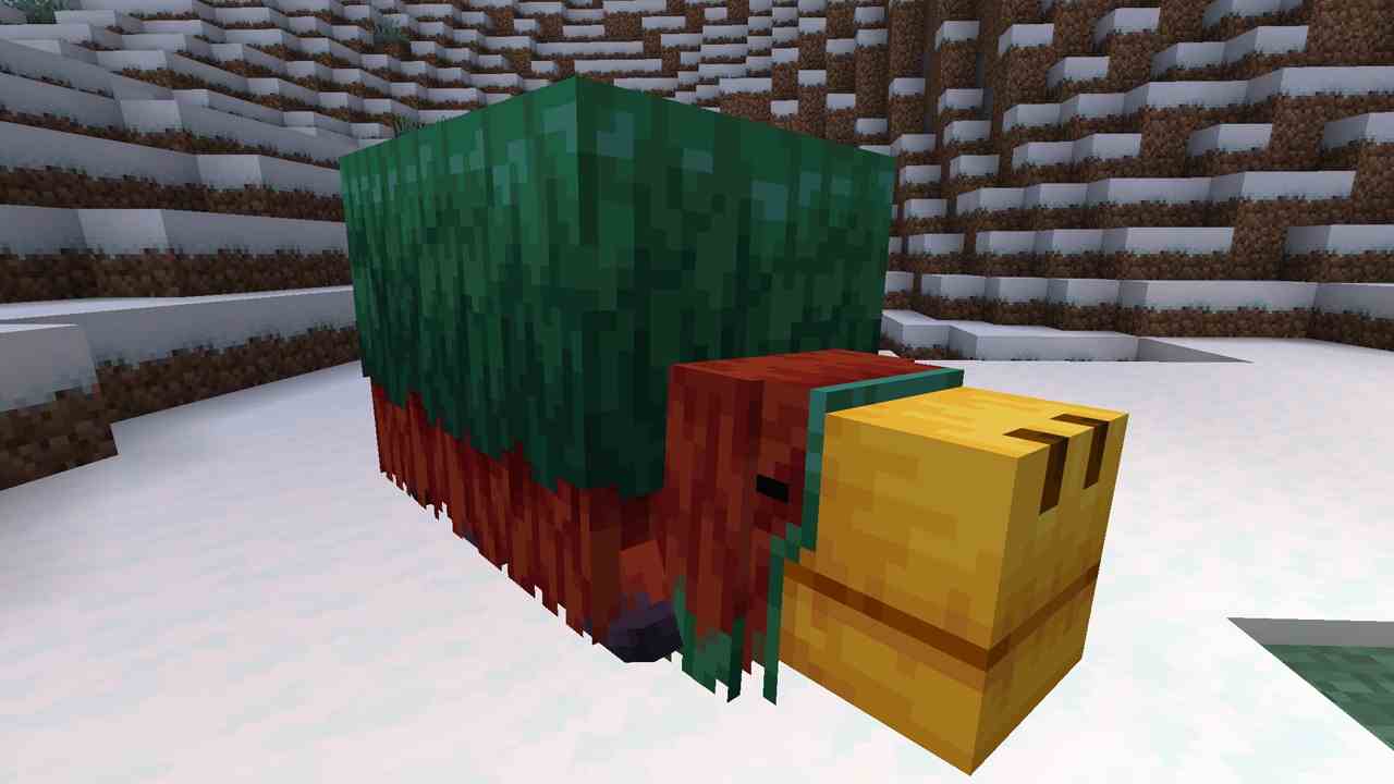 La foule Minecraft Sniffer est allongée dans la neige avec ses jambes repliées sous son torse