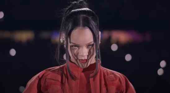 Rihanna looking into the camera at the start of her Super Bowl halftime show.
