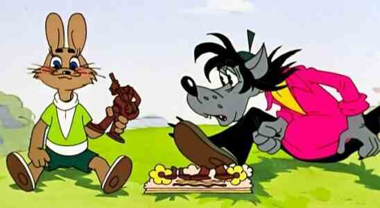 The hare and wolf from Soviet cartoon Nu, Pogodi! sit side-by-side on the grass.