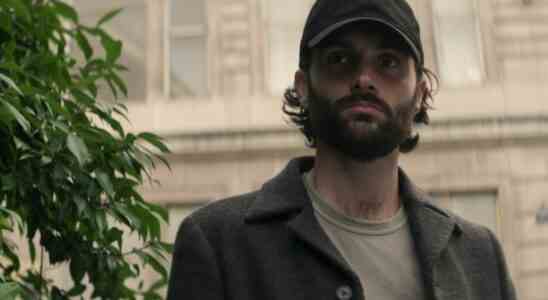 A man with dark hair and beard wearing an unmarked baseball cap; still from "You."