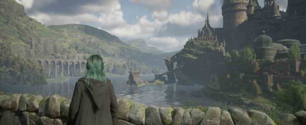 Hogwarts Legacy release times - character is looking across a lake towards Hogwarts.