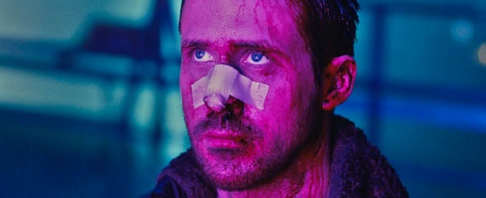 Ryan Gosling looking worse for wear looking up lit by purple light