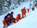 Formation sur les avalanches impliquant des patrouilleurs de ski et des techniciens militaires en recherche et sauvetage à la station de ski Mount Washington sur l'île de Vancouver. 