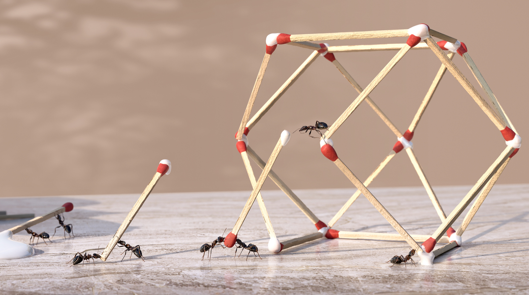 Un groupe de fourmis travaillant en équipe pour former une sculpture géométrique tridimensionnelle à partir de colle et d'allumettes.  Les fourmis sont des extrémités trempées d'allumettes dans de la colle dégoulinant d'une bouteille de colle et placées en position pour former la forme sur un plan de travail en marbre.