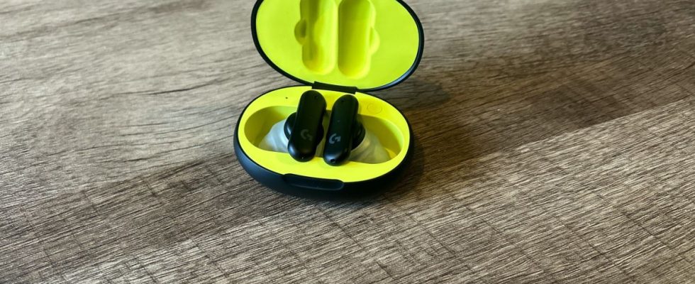 Logitech G Fits earbuds in a black and yellow case on a wooden table