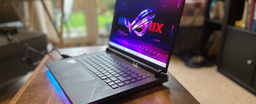 Asus ROG Strix Scar 16 gaming laptop open on a wooden table