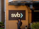 Un homme passe devant une pancarte au siège de la Silicon Valley Bank à Santa Clara, en Californie, le 13 mars.