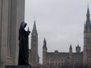 La statue représentant la justice regarde de la Cour suprême du Canada sur la Cité parlementaire à Ottawa.