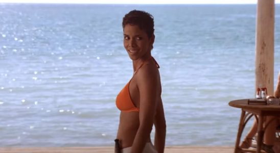 Halle Berry looks over her shoulder in an orange bikini in Die Another Day.