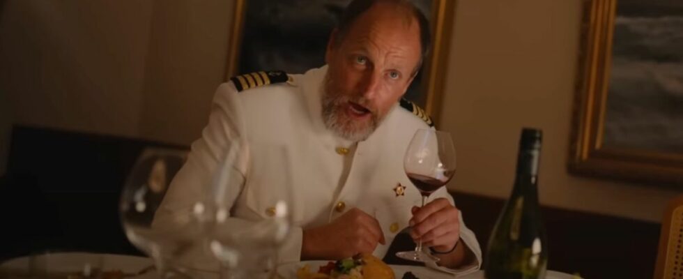 Woody Harrelson holding up a wine glass in Triangle of Sadness.