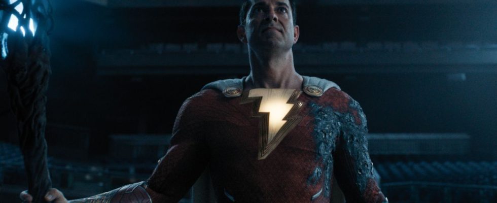 Zachary Levi stands in a baseball stadium holding a powerful staff in Shazam! Fury of the Gods.