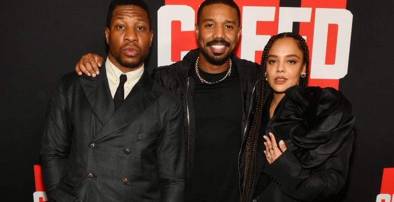 ATLANTA, GEORGIA - FEBRUARY 23: (L-R) Jonathan Majors, Michael B. Jordan and Tessa Thompson attend the CREED III HBCU fan screening presented by MGM Studios at Regal Atlantic Station on February 23, 2023 in Atlanta, Georgia. (Photo by Paras Griffin/Getty Images for MGM Studios)