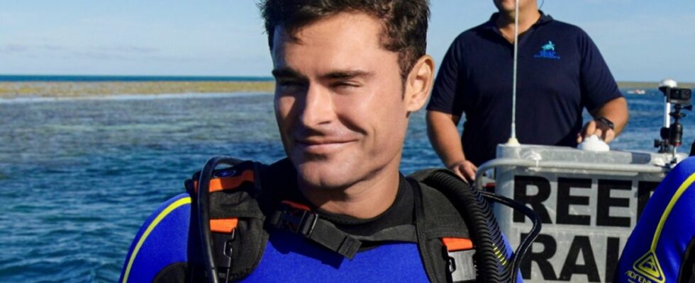 Zac Efron on a boat in a wetsuit in Down to Earth with Zac Efron