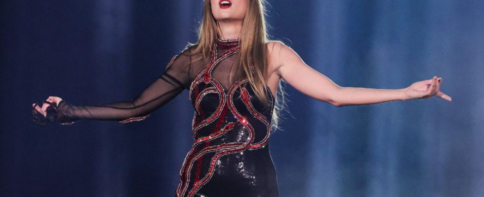 Taylor Swift in her Reputation outfit standing with her arms out