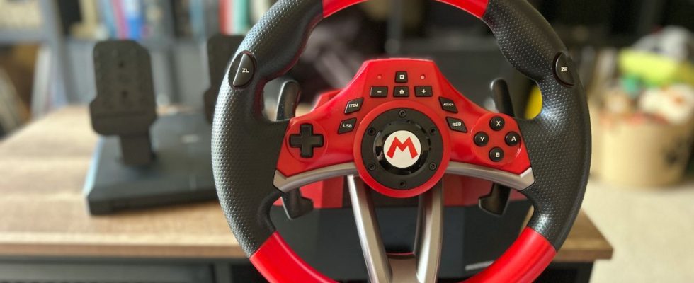 Hori Mario Kart Racing Wheel Pro Deluxe racing wheel attached to a wooden table
