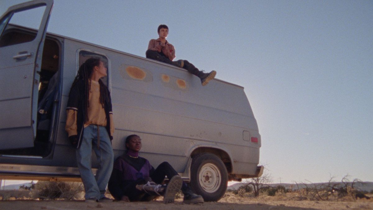 Les jeunes de How to Blow Up a Pipeline sont assis sur et devant une camionnette blanche.  On s'y appuie.  L'arrière-plan est le désert désolé de l'ouest du Texas.