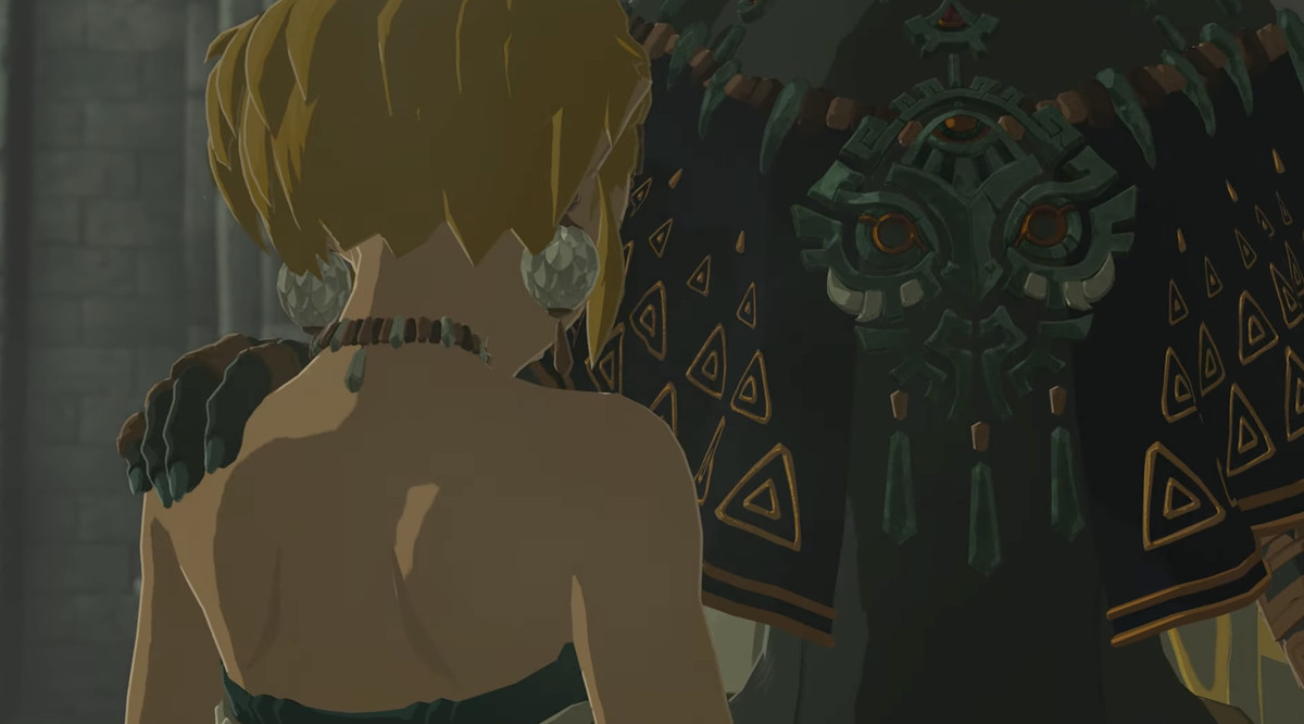 Image tirée d'une bande-annonce de The Legend of Zelda : Tears of the Kingdom.  Il montre une personne de grande taille posant sa main sur l'épaule de Zelda, mais nous ne pouvons pas voir son visage. 