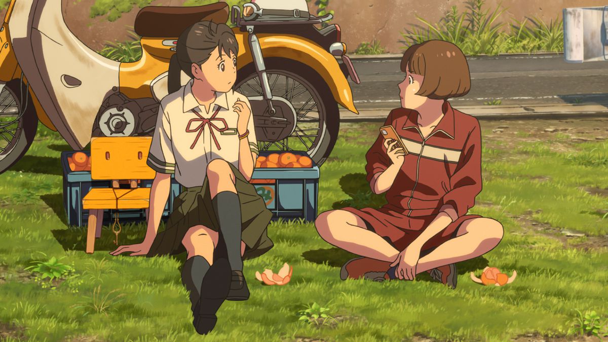 Suzume, en uniforme scolaire, mangeant des fruits au bord d'une route rurale avec Chika, en uniforme de gym.