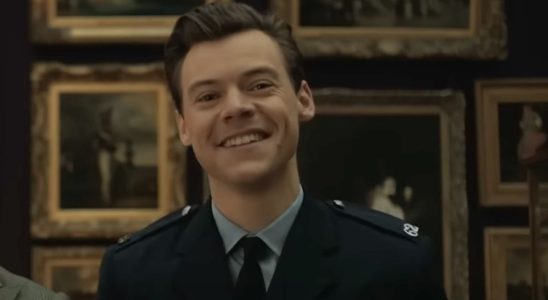 Harry Styles smiling at a painting in My Policeman.