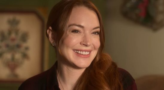 Lindsay Lohan smiling in the Falling For Christmas trailer.